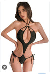 black monokini-style bodysuit characterized by its provocative, minimalist construction and extreme cutout details.